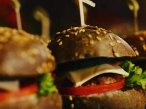 Черный бургер гриль с овощами и говяжьей котлеткой